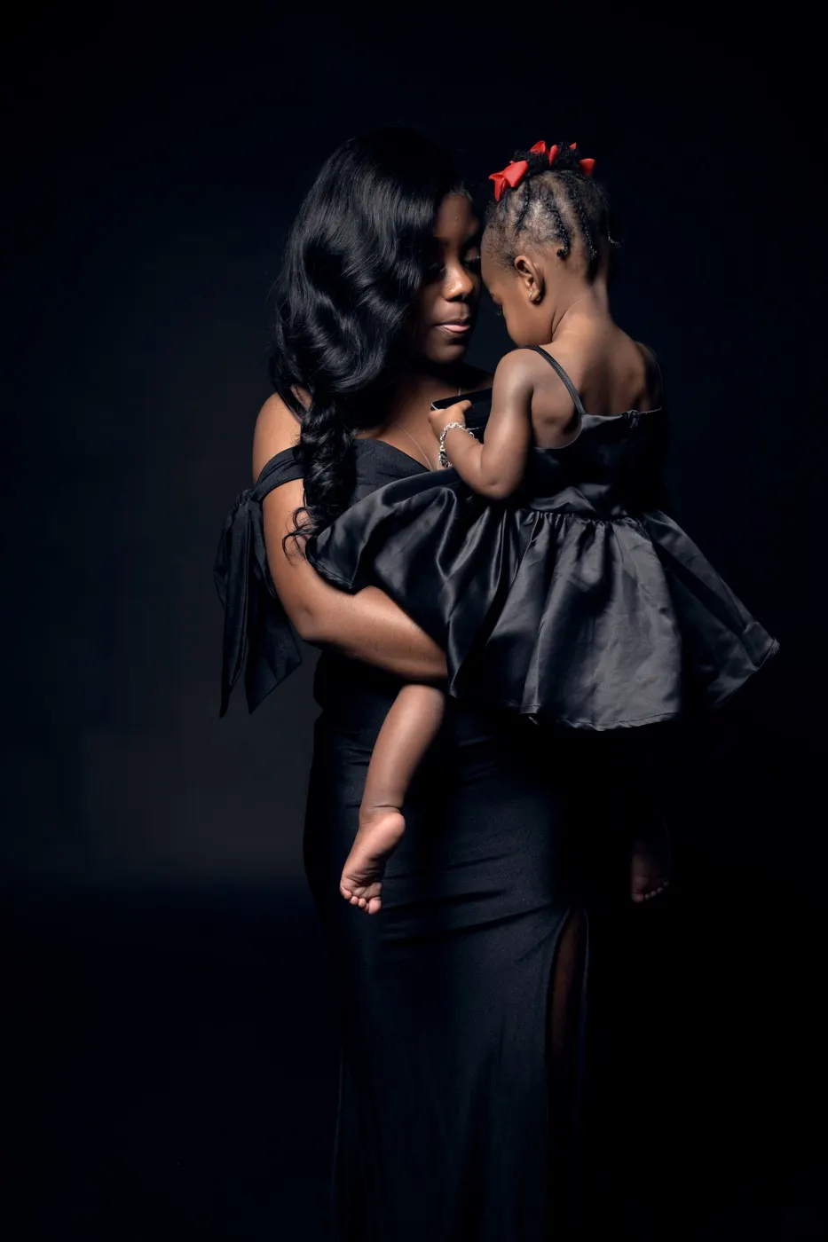 Mother holding her young daughter